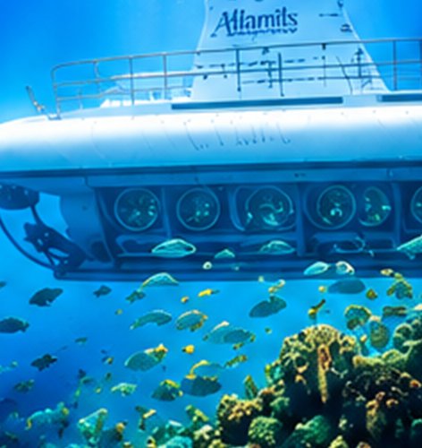 Submarine underwater beside a coral reef